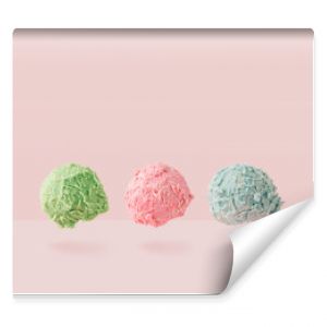 Ice cream scoops against pastel pink background. Minimal summer food concept.