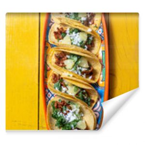 Mexican background with tacos al pastor and mexican sauces. Yellow wooden background, copy space, top view