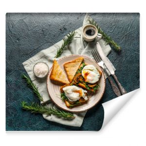 Plate with tasty egg Benedict and cup of coffee on black background