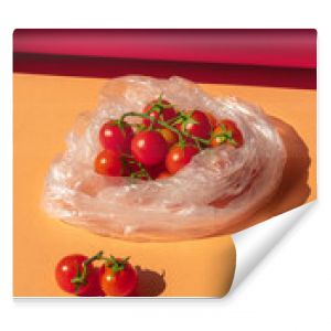 The cherry tomatoes in a transparent plastic bag. Red small tomatoes in a package