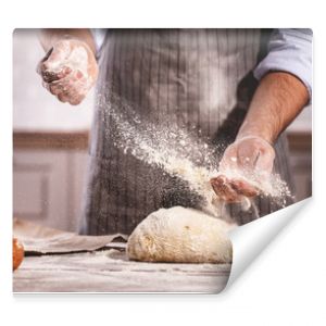 hands of baker's male knead dough