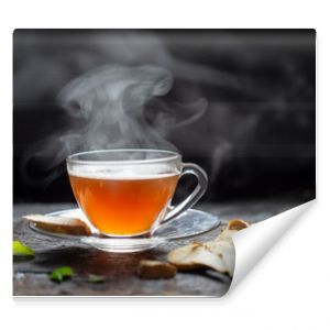 Hot Ginger tea in a glass on wood background.Hot drink . Copy space.