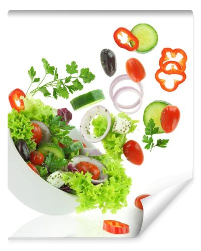 Fresh mixed vegetables falling into a bowl of salad