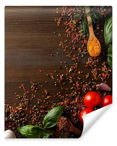 Different cooking ingredients and spices on wooden background