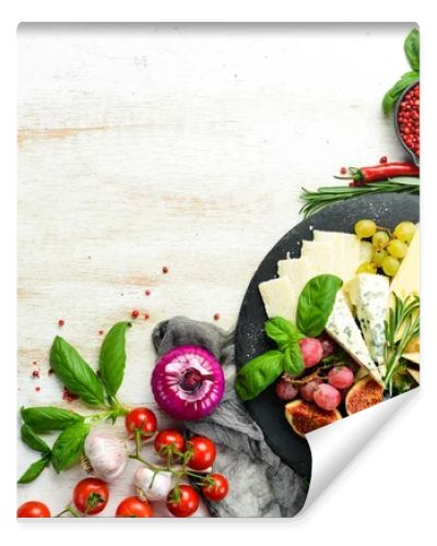 Assorted cheeses on a plate. Parmesan cheese, blue cheese and brie on a plate with grapes and figs. Antipasto. Top view.