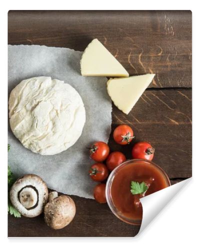 dough with ingredients for preparing pizza