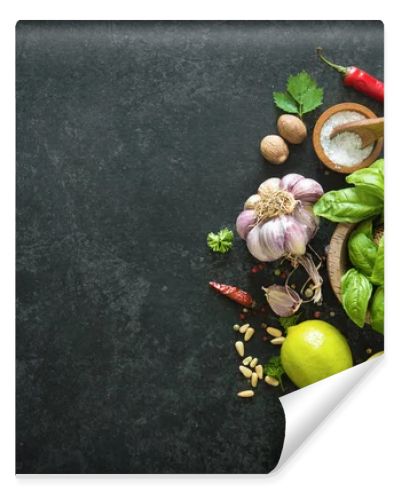 Herbs and spices on black stone table