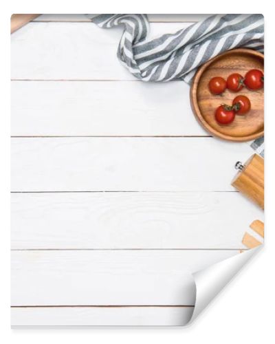 Cherry tomatoes with wooden spatula and salt grinder with table cloth on tabletop