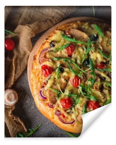 Pizza with chicken, arugula, cheese and onions on wooden rustic table. Top view