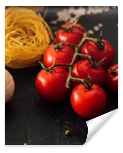 raw Italian Capellini with vegetables and seasoning on black background, panoramic shot