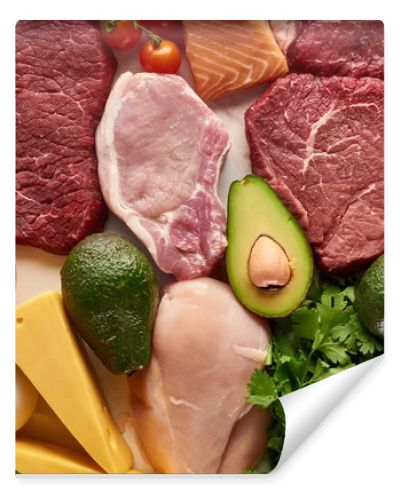 Top view of assorted raw meat, poultry, fish, eggs, vegetables, fruits, nuts, greenery and cheese 