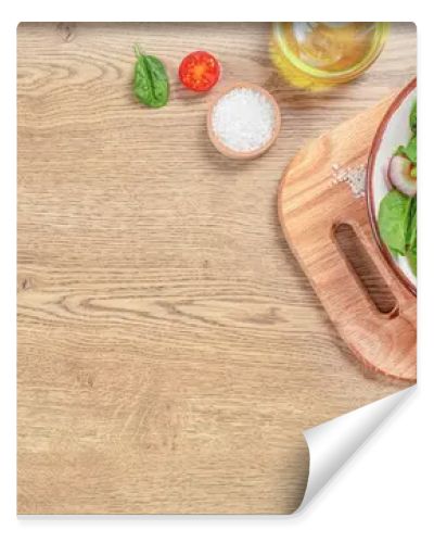 Green salad vegan leaves tomato salad on a wooden table. Long banner format. top view. copy space.