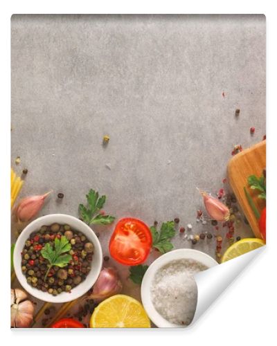 Italian food background on stone table. Macaroni, basil and vegetables.