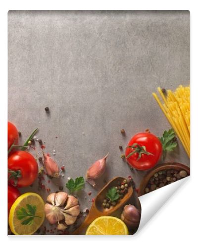 Italian food background on stone table. Macaroni, basil and vegetables.