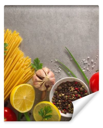 Italian food background on stone table. Macaroni, basil and vegetables.