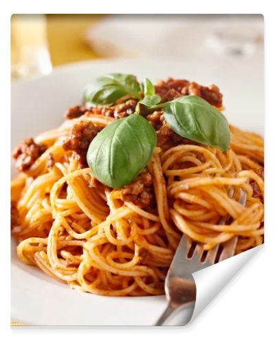 Spaghetti with basil garnish in meat sauce