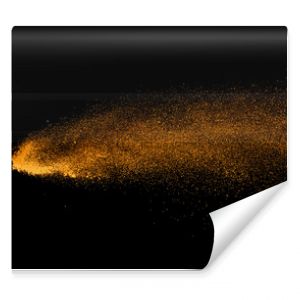 Closeup of orange powder particle splash isolated on black  background.