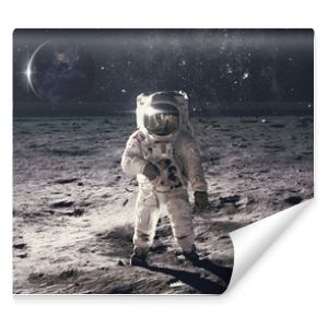 Astronaut on rock surface with space background. Elements of this image furnished by NASA