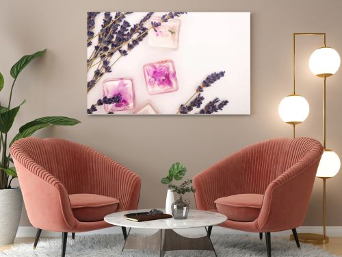 top view of frozen lavender flowers near twigs on white background