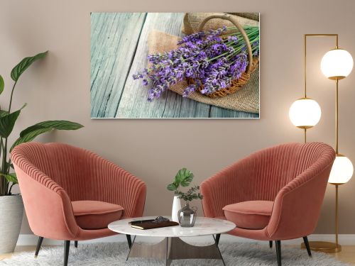 lavender flowers in a basket with burlap on the wooden backgroun