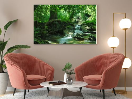 panorama view of nice waterfall and pond in green tropical environment