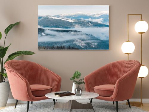 scenic view of snowy mountains with pine trees in white fluffy clouds