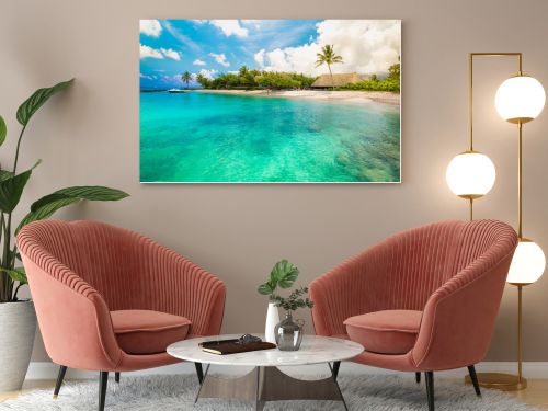 Huahine, French Polynesia. South Pacific. Tropical vacation landscape with lagoon, white sandy beach and palm trees on the island.