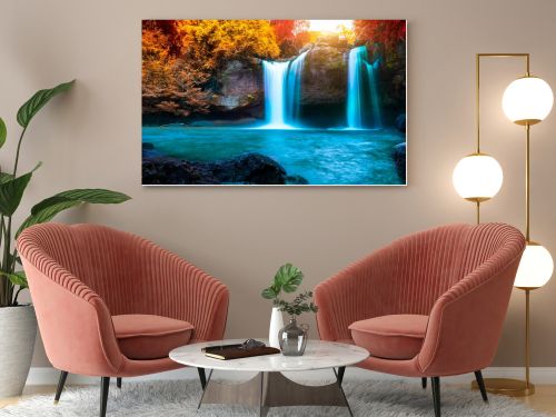 Water fall with red leaf in forest background.