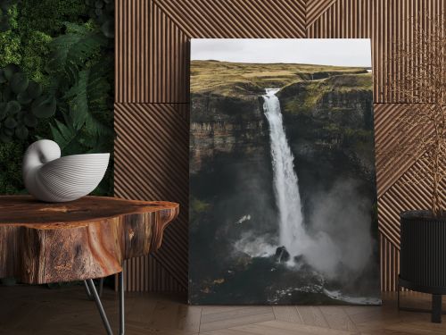 aerial view of icelandic landscape with Haifoss waterfall and green hills