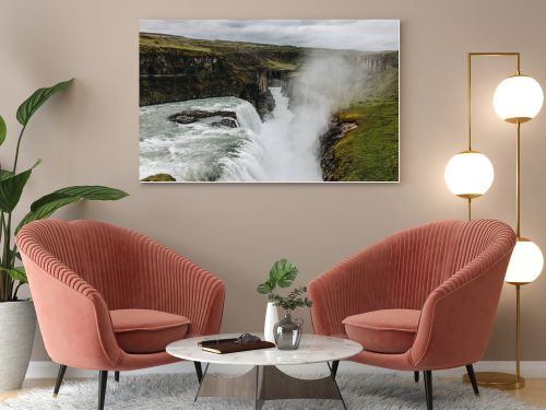 scenic view of steam above beautiful Gullfoss waterfall  flowing through highlands in Iceland