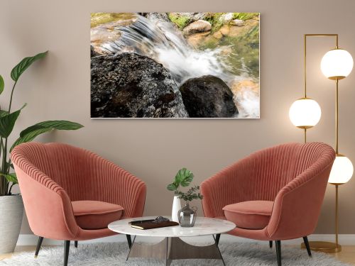 steam with water flowing on rocks near grass in park 