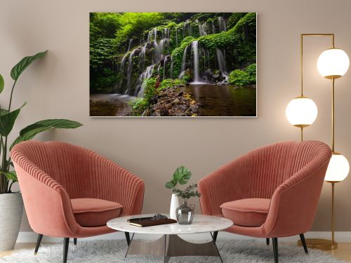 Tropical landscape. Beautiful hidden waterfall in rainforest. Adventure and travel concept. Nature background. Slow shutter speed, motion photography. Banyu Wana Amertha waterfall Bali, Indonesia