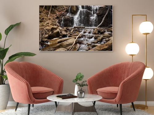 River stream waterfall in forest landscape. Tranquil waterfall scenery in the middle of green forest