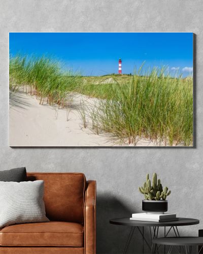 Beautiful dune landscape with traditional lighthouse at North Sea