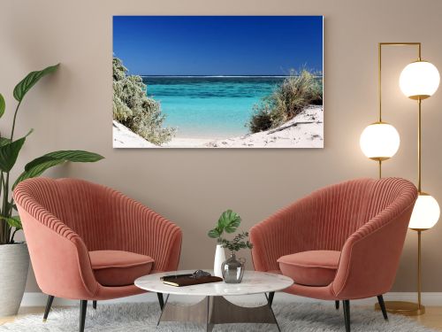 View of the pristine turquois waters through gap in the dunes at Ningaloo reef