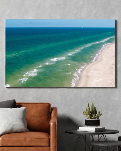 Aerial drone view of long sandy beach and green Baltic Sea coastline with pine forest  summer coastal landscape photography