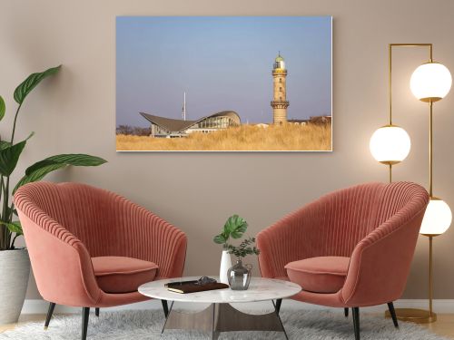 Lighthouse in Warnemuende, Germany with marram grass on sand dunes on the foreground. High quality photo