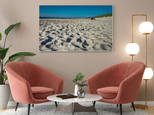 Coastal area in Lithuania Coastal scenery with sandy beach, dunes with marram grass and rough sea on a clear summer day with blue sky.