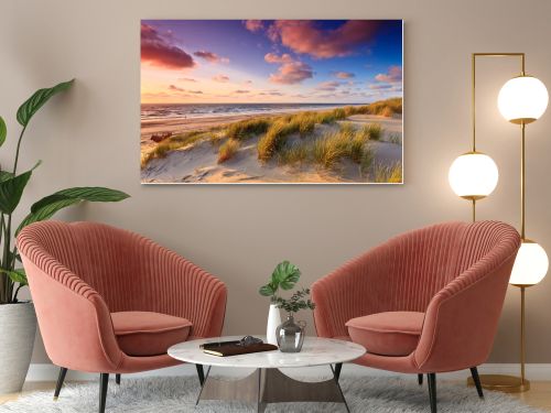 Seaside with sand dunes at sunset