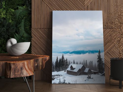 scenic view of snowy mountain village with pine trees and wooden houses