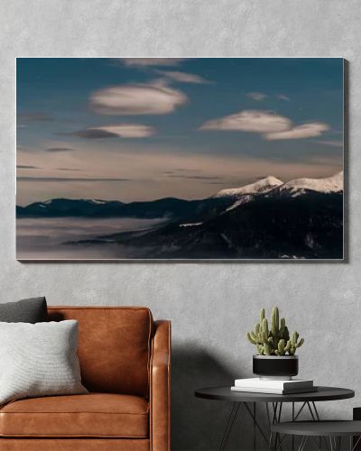 scenic view of snowy mountains with white fluffy clouds in evening, panoramic shot