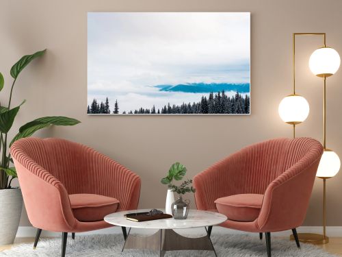 scenic view of snowy mountains with pine trees and white fluffy clouds