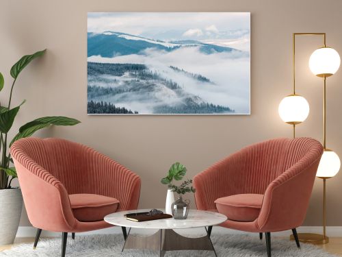 scenic view of snowy mountains with pine trees in white fluffy clouds