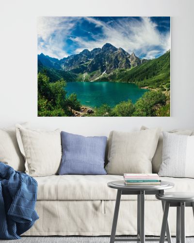 View on the turquoise color lake between high and rocky mountains. Beautiful alpine landscape. 