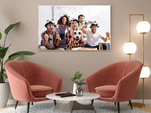 cheerful multicultural football fans shouting while watching championship at home