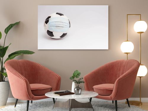 soccer ball in medical mask on white with copy space