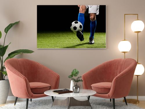 cropped view of man playing with ball on grass isolated on black