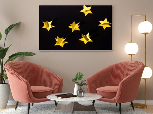 decorative yellow paper stars isolated on black 