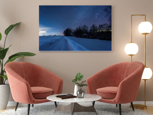 starry dark sky and snowy road in carpathian mountains at night in winter