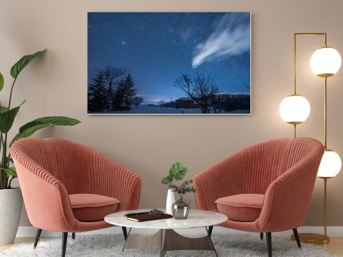 starry dark sky and house in carpathian mountains at night in winter